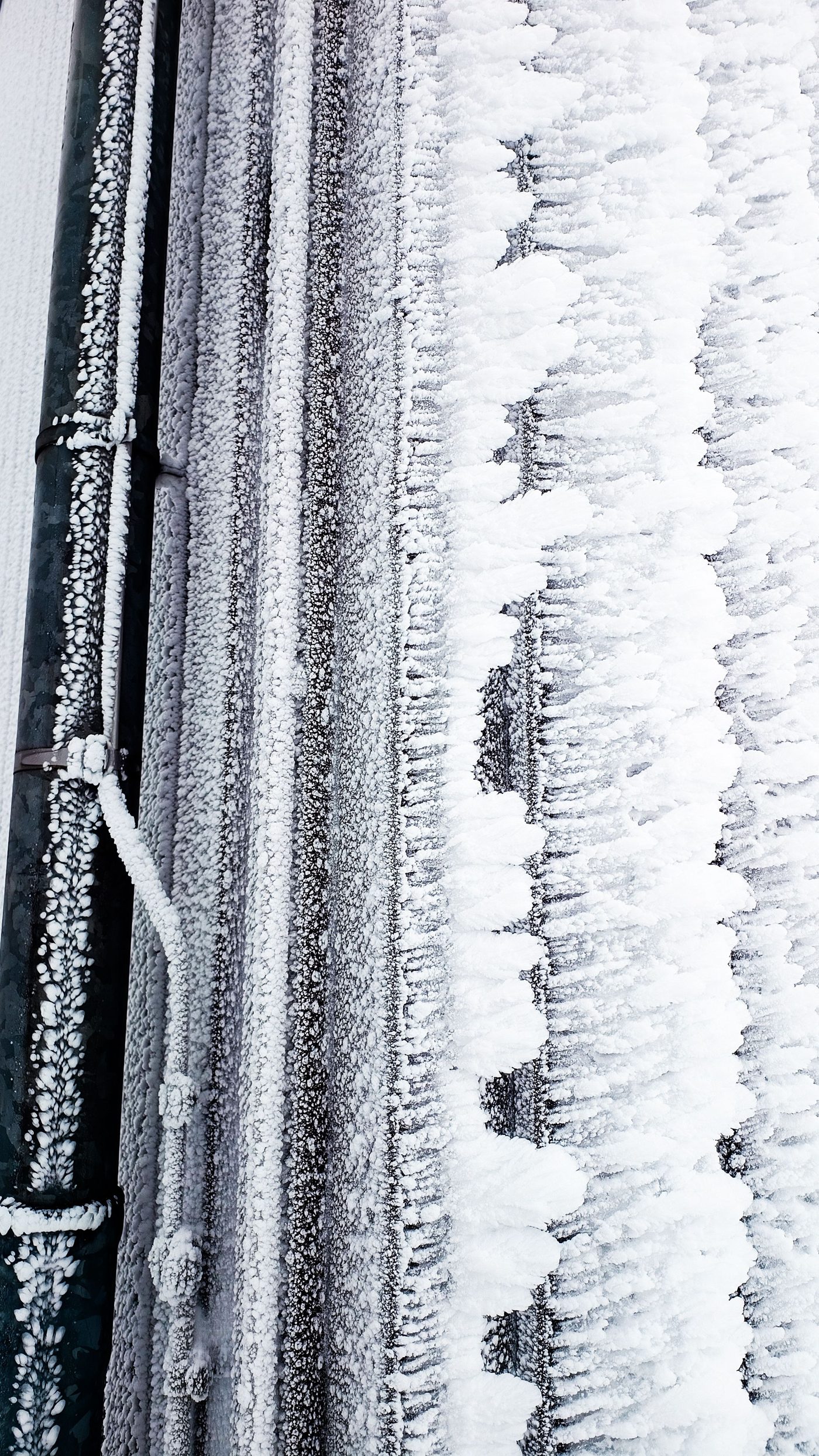 Pipes covered in thick frost on a freezing day